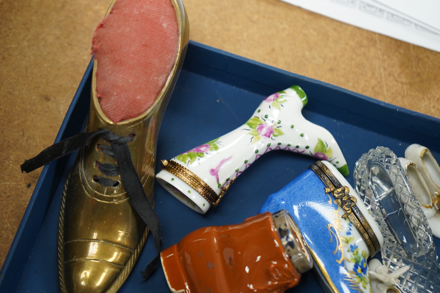 A collection of assorted miniature model shoes including pin cushions, one with modern silver mount